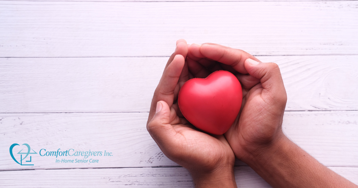 Hands holding a heart shape represent the care and support that those caring for seniors at home need.